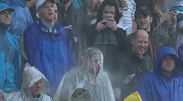 Fans wear rain gear prior to an NFL football game between the New