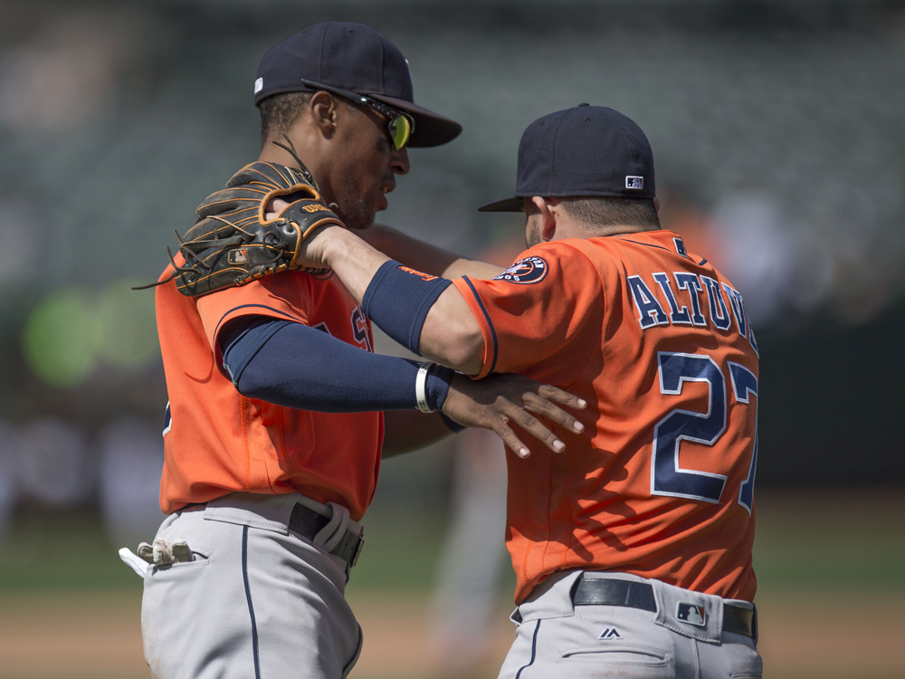 Detroit Tigers right fielder Jake Marisnick (15) points to the dugout after  hitting an RBI-triple in the top of the second inning in a baseball game  against the Texas Rangers in Arlington