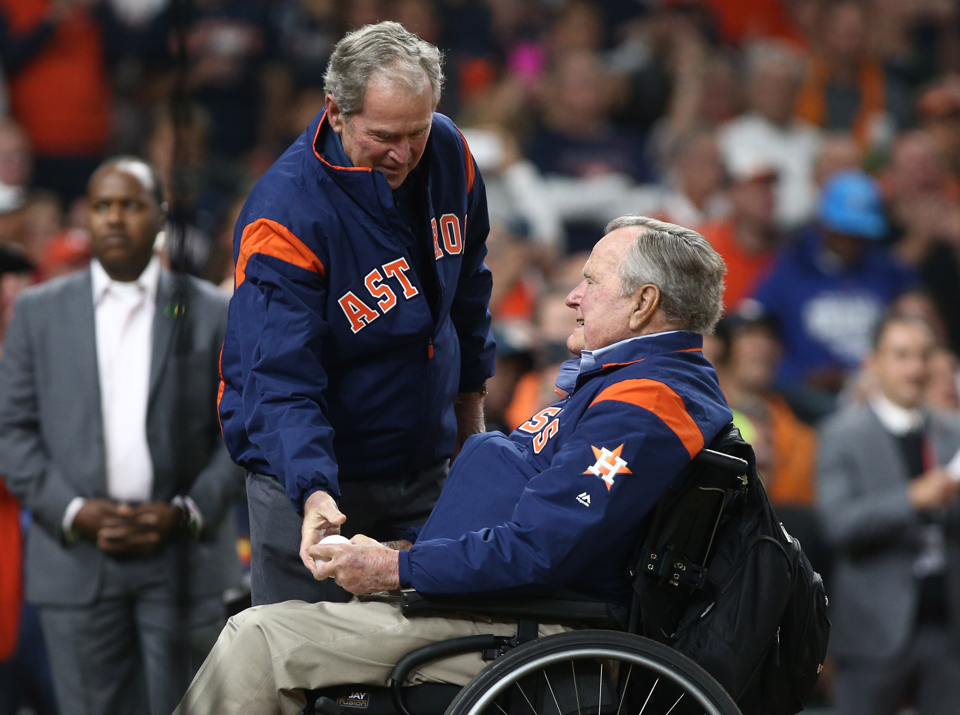 Photos: Bush 43 throws out 1st pitch after getting ball from dad